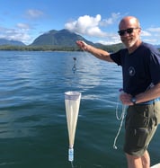 Harry Nelson collecting sample with plankton net for FlowCam analysis